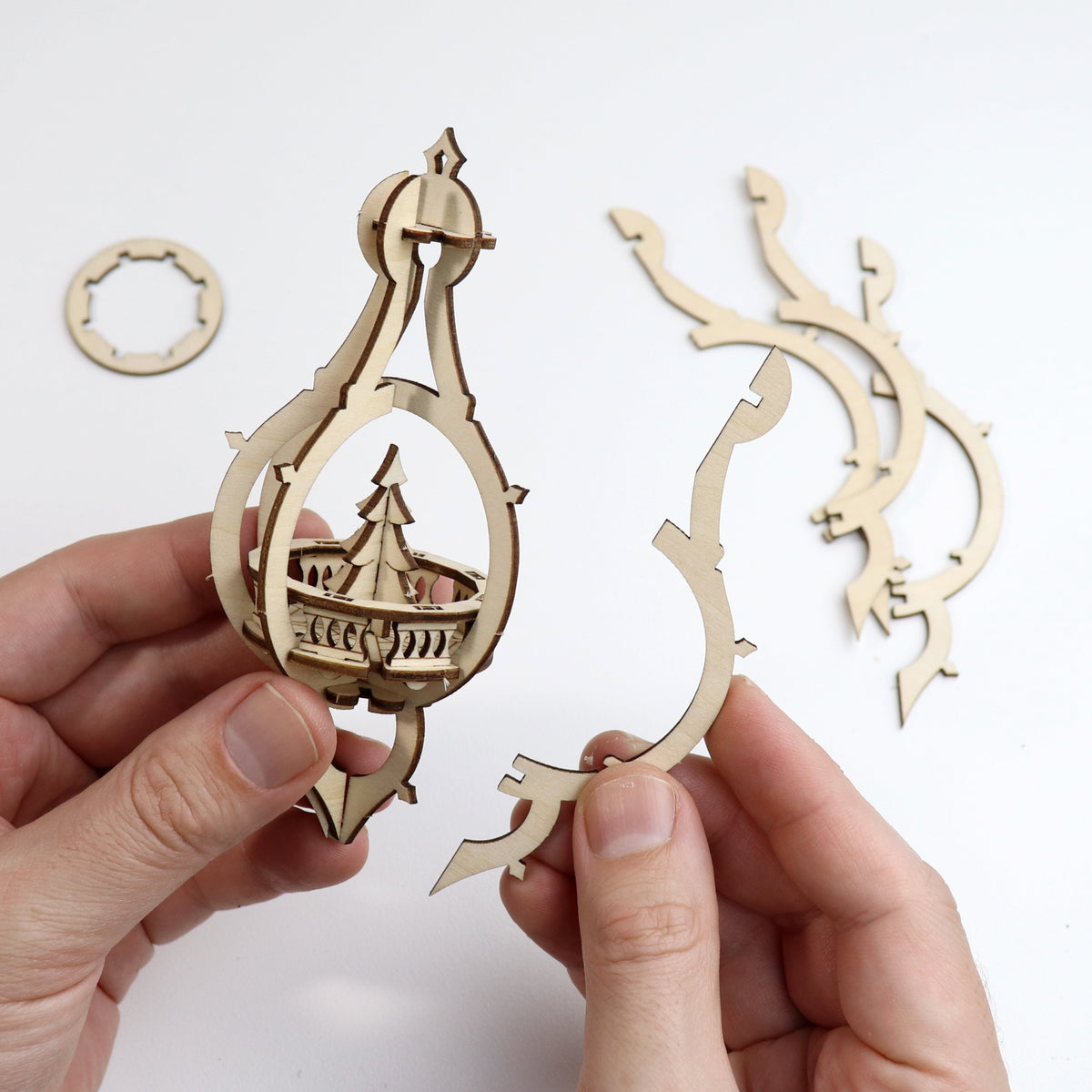 Happy Holidays DIY wooden Christmas bauble set, being assembled