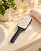 Self-cleaning hairbrush on a bathroom vanity