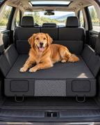 Dog resting on the back seat extender in a car