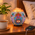 A calm bedroom nightstand scene with the glowing himalayan salt lamp in the carved bowl