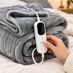 Close-up of a hand adjusting the temperature controller of the smart heated blanket