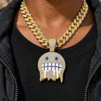 Close-up of the iced face pendant and Cuban link chain on a chest