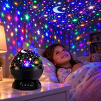 A child's bedroom at night filled with colorful stars from the rotating star projector