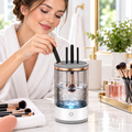 A woman at her vanity using the electric makeup brush cleaner