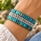Close-up of the triple-layer natural stone bead bracelet on a wrist showing the stone textures and colors in detail