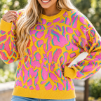 Close-up of the bold abstract knit print and ribbed cuffs of the oversized sweater
