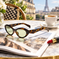 Cat eye sunglasses styled on a cafe table